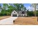 Charming new construction home with a well-manicured front yard and a paved driveway at 9200 Otter Ct, Middlesex, NC 27557
