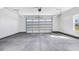 This garage features a roll-up door, concrete floors, and a sunny window at 9200 Otter Ct, Middlesex, NC 27557