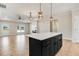 Open concept with the kitchen island, and a view into the large living room with fireplace at 9200 Otter Ct, Middlesex, NC 27557