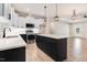 Spacious kitchen featuring white cabinets, black island, stainless steel appliances, and island seating at 9200 Otter Ct, Middlesex, NC 27557