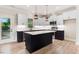 Modern kitchen featuring white cabinets, black island, stainless steel appliances, and pendant lighting at 9200 Otter Ct, Middlesex, NC 27557
