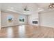 Bright living room with hardwood floors, fireplace, and natural light streaming through the window at 9200 Otter Ct, Middlesex, NC 27557