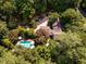 Aerial view of a home with a pool and mature landscaping at 102 Antler Point Rd, Chapel Hill, NC 27516