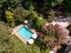 Aerial view of pool and backyard with lush, mature trees at 102 Antler Point Rd, Chapel Hill, NC 27516