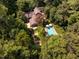 Aerial view displays a home with a luxurious pool and gardens at 102 Antler Point Rd, Chapel Hill, NC 27516