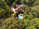 Aerial view showcases a home with a backyard pool and lush landscaping at 102 Antler Point Rd, Chapel Hill, NC 27516
