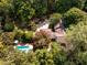 Aerial photograph showcases a house, pool, garden, and lush landscaping at 102 Antler Point Rd, Chapel Hill, NC 27516