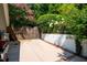 Private backyard featuring lush greenery, a BBQ grill, and a charming wooden gate at 102 Antler Point Rd, Chapel Hill, NC 27516