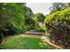 Lush backyard featuring garden beds and green space, ideal for outdoor activities at 102 Antler Point Rd, Chapel Hill, NC 27516