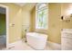 Modern bathroom featuring a standalone tub, marble countertops, and stylish fixtures at 102 Antler Point Rd, Chapel Hill, NC 27516
