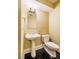 A clean powder room features a pedestal sink, a black tile floor and neutral walls at 102 Antler Point Rd, Chapel Hill, NC 27516