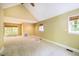 Large bedroom has plush carpet, a fan, and natural light from three windows at 102 Antler Point Rd, Chapel Hill, NC 27516