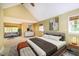 Spacious bedroom with sitting area, a fan, and natural light from three windows at 102 Antler Point Rd, Chapel Hill, NC 27516