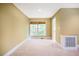 Neutral bedroom featuring natural light from a window with woven shades and plush carpeting at 102 Antler Point Rd, Chapel Hill, NC 27516