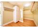 Walk-in closet with built-in shelving, wooden floors, and ample storage space at 102 Antler Point Rd, Chapel Hill, NC 27516