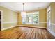 Sunny dining room featuring hardwood floors, natural light, and trim at 102 Antler Point Rd, Chapel Hill, NC 27516