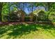 Beautiful home exterior showcasing its well-manicured lawn and mature trees at 102 Antler Point Rd, Chapel Hill, NC 27516
