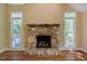 Cozy stone fireplace as a focal point with natural light streaming through large windows at 102 Antler Point Rd, Chapel Hill, NC 27516