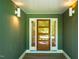 Elegant front door with sidelights and decorative lighting, creating a warm entrance at 102 Antler Point Rd, Chapel Hill, NC 27516