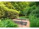 Well-maintained garden plots surrounded by lush greenery, perfect for gardening enthusiasts at 102 Antler Point Rd, Chapel Hill, NC 27516