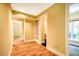 Hallway featuring hardwood floors, built-in shelving, and access to well-lit rooms at 102 Antler Point Rd, Chapel Hill, NC 27516