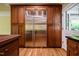 This kitchen boasts a large stainless steel refrigerator surrounded by custom cabinets and hardwood floors at 102 Antler Point Rd, Chapel Hill, NC 27516
