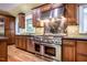 Gourmet kitchen featuring stainless steel appliances, wood cabinets, and hardwood floors at 102 Antler Point Rd, Chapel Hill, NC 27516