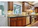 Kitchen showcasing stainless steel appliances, custom cabinets, sink, and backsplash with a window view at 102 Antler Point Rd, Chapel Hill, NC 27516