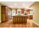 Open kitchen with a large center island, stainless steel appliances, and wood cabinetry at 102 Antler Point Rd, Chapel Hill, NC 27516