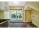 This cozy laundry room has exposed brick floors and is brightly lit by a double window at 102 Antler Point Rd, Chapel Hill, NC 27516