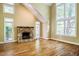 Open living room with a stone fireplace, large windows, and high ceilings, creating an airy feel at 102 Antler Point Rd, Chapel Hill, NC 27516