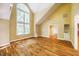 Large living room with hardwood floors, vaulted ceilings, and bright arched windows at 102 Antler Point Rd, Chapel Hill, NC 27516
