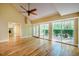 Sunlit living area with hardwood floors, ceiling fan, and patio access through sliding glass doors at 102 Antler Point Rd, Chapel Hill, NC 27516