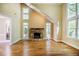 Spacious living room with a stone fireplace, hardwood floors, and ample natural light at 102 Antler Point Rd, Chapel Hill, NC 27516