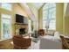 Bright living room featuring a stone fireplace, large windows, and comfortable seating at 102 Antler Point Rd, Chapel Hill, NC 27516