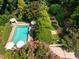 Aerial view showcasing a private pool with lounge chairs and garden at 102 Antler Point Rd, Chapel Hill, NC 27516