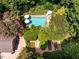 Aerial view of a pristine backyard pool featuring umbrella-shaded seating at 102 Antler Point Rd, Chapel Hill, NC 27516