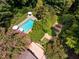 An aerial shot captures a backyard oasis with a pool and lush foliage at 102 Antler Point Rd, Chapel Hill, NC 27516