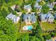Aerial view of the home showcasing its backyard pool, deck, and surrounding neighborhood at 102 Traviliah Oaks Ln, Cary, NC 27518