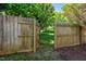 Wooden fence with an open gate, leading to the backyard at 102 Traviliah Oaks Ln, Cary, NC 27518