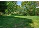 Expansive backyard with mature trees and open green space at 102 Traviliah Oaks Ln, Cary, NC 27518