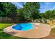 Outdoor in-ground pool with a concrete patio surrounded by greenery at 102 Traviliah Oaks Ln, Cary, NC 27518