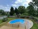 An in-ground swimming pool is the centerpiece of a lush, green backyard at 102 Traviliah Oaks Ln, Cary, NC 27518