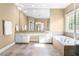 Bright bathroom with soaking tub, granite countertop, and tiled floors at 102 Traviliah Oaks Ln, Cary, NC 27518