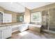 Bathroom featuring granite countertops, a tub, and glass-doored shower at 102 Traviliah Oaks Ln, Cary, NC 27518