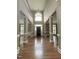 Grand foyer with a stunning chandelier, soaring ceilings, and dark wood flooring at 102 Traviliah Oaks Ln, Cary, NC 27518