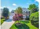 Charming two-story home with brick and siding, manicured lawn, and mature trees at 102 Traviliah Oaks Ln, Cary, NC 27518