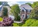 Beautiful two-story home with brick facade, manicured lawn, and mature trees at 102 Traviliah Oaks Ln, Cary, NC 27518
