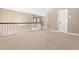 Spacious hallway with carpet flooring and wood railing overlooking the entry at 102 Traviliah Oaks Ln, Cary, NC 27518