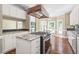 Kitchen island with granite countertops and stainless steel appliances at 102 Traviliah Oaks Ln, Cary, NC 27518